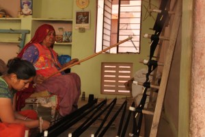 Women preparing the loom for weaving
