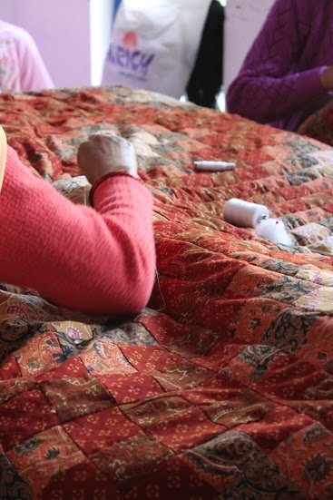 Gudri Work - A Woman making Gudri Quilt